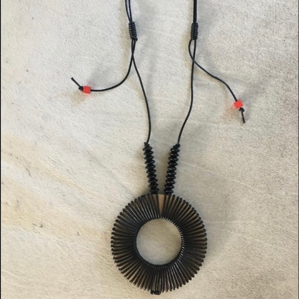 XL leather necklace adjustable with beige 6 in diameter ring and wood beads.